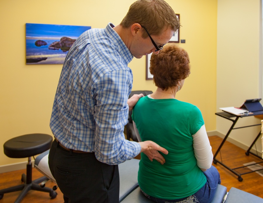Dr Favero examining spine of patient