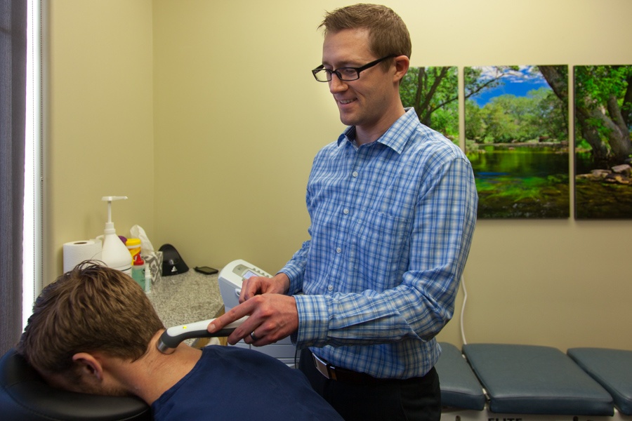 Dr Favero applying ultrasound therapy for headaches