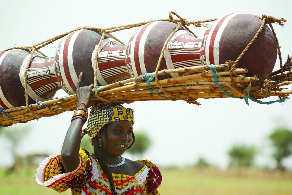 common causes and cures for headaches, woman carrying on head